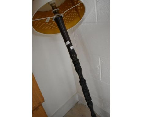 A traditional turned standard lamp, possibly fashioned from a newel post