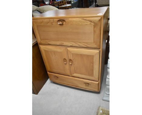 A light Ercol Windsor style bureau/cocktail cabinet, approx. dimensions H110 W82 D44cm