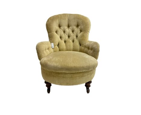 19th century armchair, upholstered in button pale yellow fabric with sprung seat, raised on turned feet with brass and cerami
