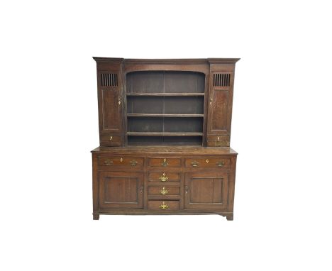 George III oak dresser, projecting cornice over three tier plate rack flanked by reeded uprights and two cupboards, enclosed 