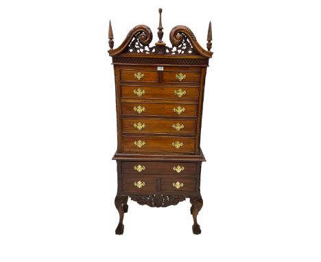 Chippendale style mahogany finish chest on chest, broken swan neck pediment with pierced foliate design over fretwork cornice