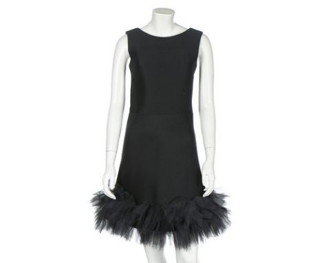 A Maggy Rouff black zibeline mini dress, circa 1965, labelled, the hem trimmed with silk raw-edged ruffles, the cleverly cons