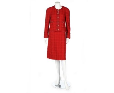 A Chanel red bouclé wool suit, 1990s, Boutique labelled, the jacket edged with silk braid and with gilt double 'C' knot-shape