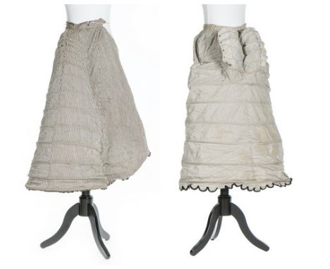 Two striped calico bustle petticoats, 1870s, another in black challis; and a white starched muslin ruffled 'tail' (4)   CONDI