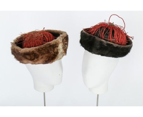 Two winter hats, Chinese, late 19th-early 20th century, edged in fur with red tassels; together with a pair of black silk boo
