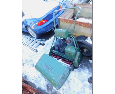 An Atco 80CO Royal B24 petrol driven cylinder mower, with a Briggs &amp; Stratton starter engine.