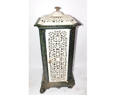 A French early 20thC cast iron and enamel conservatory heater, of canted square form with pierced foliate panels, raised on s