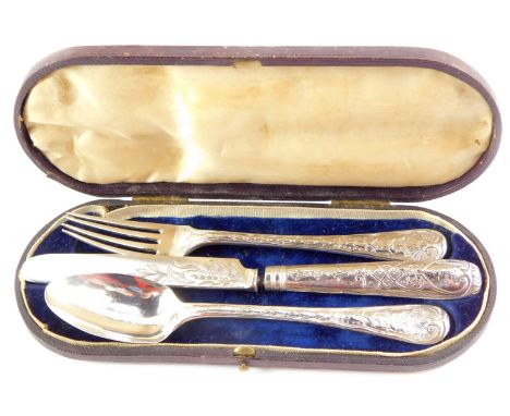 A Victorian silver three piece cutlery set, with embossed floral and engraved foliate decoration, cased, comprising knife, fo