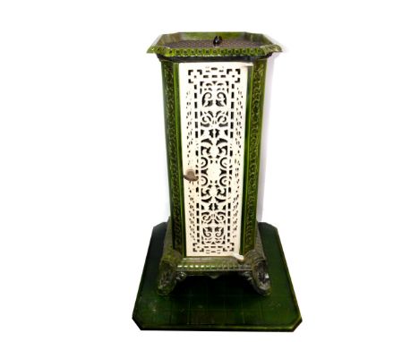 A French early 20thC cast iron and enamel conservatory heater, of canted square form, with pierced repeating foliate decorati