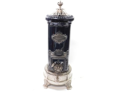 A St Joseph Couvin Le Salamandre stove, cast iron, polished white metal and black enamel, of cylindrical form, the domed cove