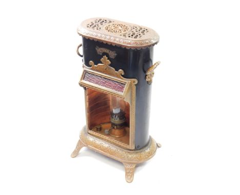 A Petrolux late 19thC black tin and brown enamel stove, with copper burner and glass chimney, moulded with repeating leaf dec