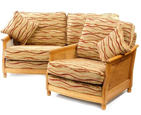 An Ercol elm and bergere two seater sofa, c2007, with wavy striped fabric cushions, 101.5cm wide, 93cm deep, together with a 