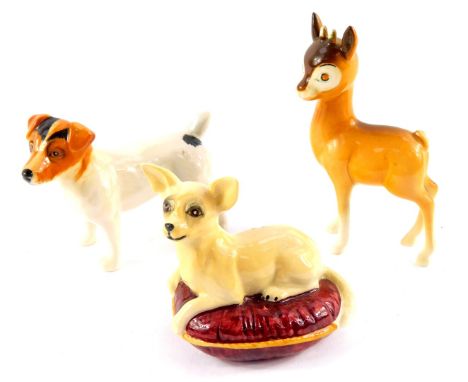 A Beswick Babycham deer, Jack Russell Terrier, and a figure of a Chihuahua, modelled lying on a maroon coloured cushion. (3)