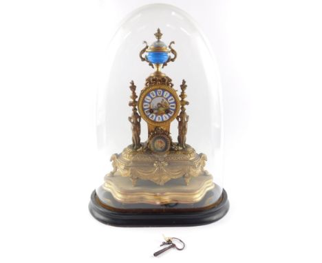 A French late 19thC gilt metal and porcelain mantel clock, the circular dial painted with a rural landscape and Roman numeral