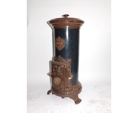 A Godin 20thC cast iron enamel and tin wood burning stove, of cylindrical form, raised on three scroll feet, 80cm high, 24cm 