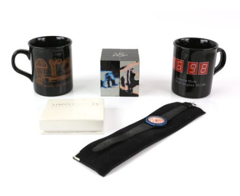 A collection of music tour memorabilia - including Depeche Mode and Erasure mugs, a U2 Pop infinity cube, a Dire Straits watc