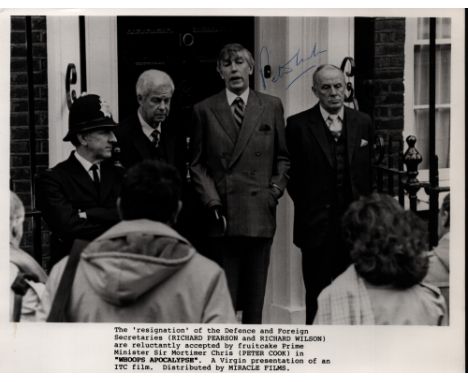 Peter Cook, English satirist and comedy actor. A signed 10x8 lobby card from the film, 'Whoops Apocalypse' (1986), with Cook 