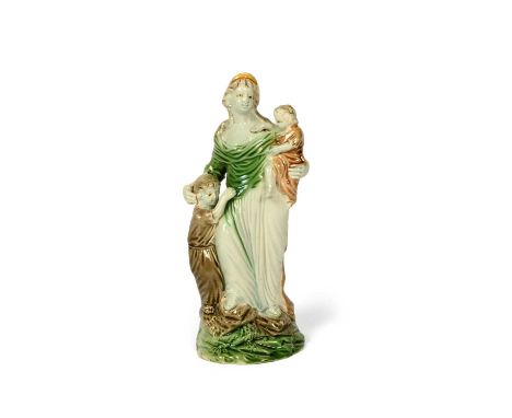 A Ralph Wood figure of Charity, c.1790, modelled as a maiden standing on a rocky base, holding an infant on her left hip, a s