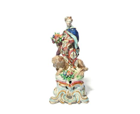 A tall Bow figure of Ceres, c.1765, emblematic of Earth from the Four Elements, standing before a recumbent lion, holding a c