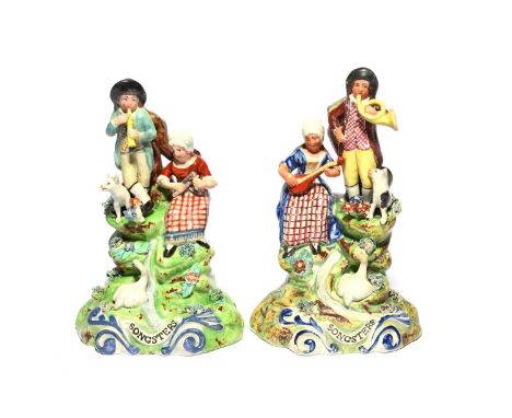A matched pair of Walton pearlware figure groups of The Songsters, 19th century, each raised on a rocky base, one with a boy 