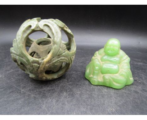 A carved ball in a ball (in a ball -3 balls) in a green material and a 'Jade' Buddha