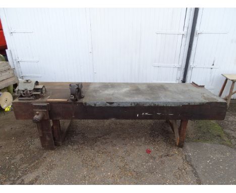 Very large metal topped wooden workbench with 2 vices and bench grinder (no plug). Appears to have some historic woodworm as 