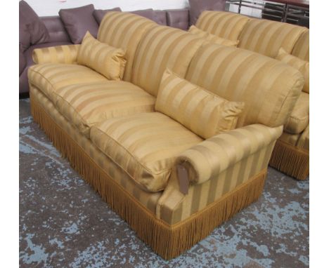 PETER DUDGEON SOFA, three seater, with gold striped upholstery and tasselled fringing, 224cm L. (with faults)