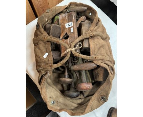 A vintage carpenters bag of antique tools including Moulding planes, braces, drills etc
