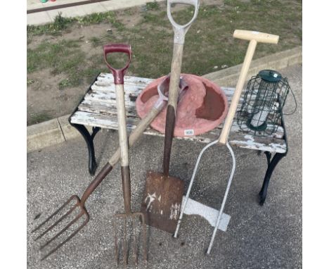 A quantity of garden tools, bird feeder, bench &amp; decorative wall art of a womans face