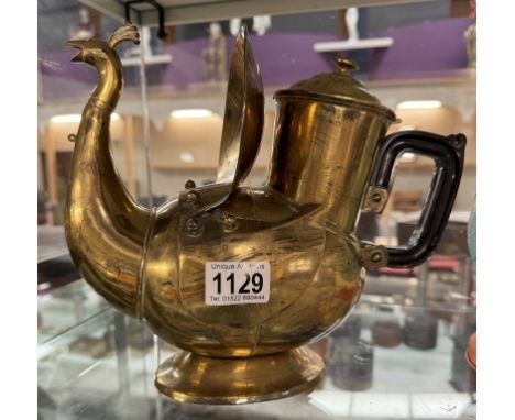 A vintage brass peacock shaped hot water jug