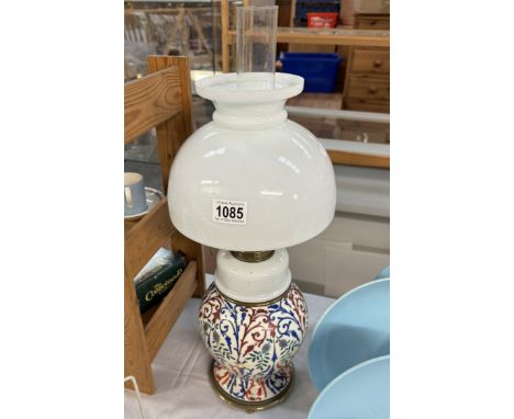 A Victorian oil lamp with later shade