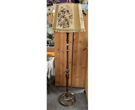 An Edwardian oak standard lamp