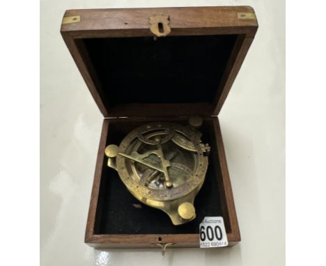 A brass marine sundial in hard wood box