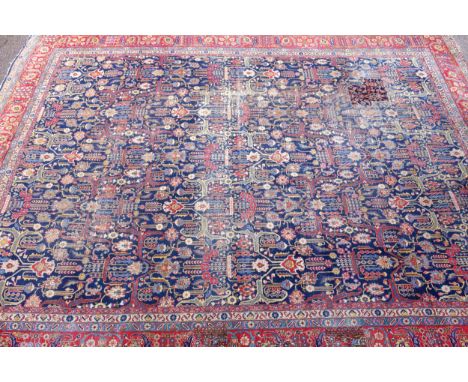 Large Early 20th Century Persian Tabriz carpet, the indigo field with all-over palmette, rosette, and vine decoration, within