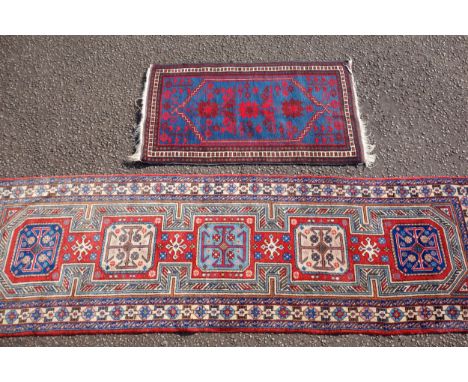 Caucasian Kazak runner, the madder field with 5 connected medallions within an ivory stylised geometric rosette border and in