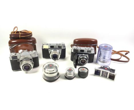 3 Kodak Retina 35mm cameras, III C, Reflex, and, III S; 3 lenses, and a stereo attachment. (7)