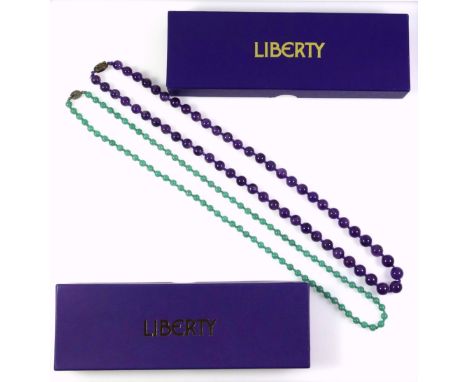 An amethyst necklace with a white metal clasp stamped silver, length 67cm, the beads are graduated from 0.8cm to 1.1cm approx