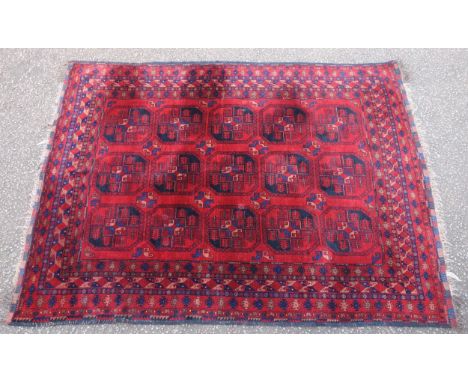 Afghan Dali Carpet, the madder field with 3 rows of octagonal guls, within multiple geometric borders, and rosette guards, 27