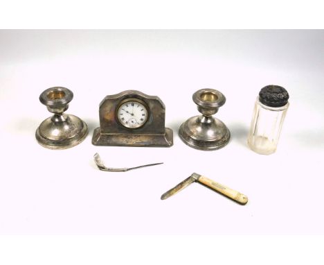 Pair of silver dwarf candlesticks, by Broadway &amp; Co., Birmingham, 1958, H.6.5cm; silver mounted desk timepiece, Birmingha