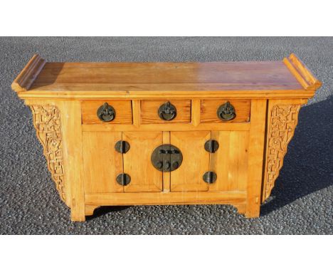 Chinese elm altar table style side cabinet, the rectangular top with upturned moulded scroll ends, supported by 2 blind fret 