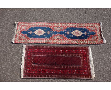 Persian rug, the madder field with all-over geometric pattern, within a floral border and rosette guards, 176 x 85cm, and a r