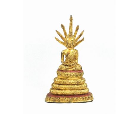 18th Century Thai gilt bronze figure of Buddha, seated in Vajrasana on a lotus throne supported by Mucilinda, (the 7-headed s