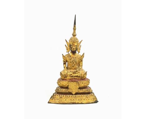 18th Century Thai gilt bronze figure of a buddha, seated in Vajrasana on a stepped lotus base with red painted tiers, his rig