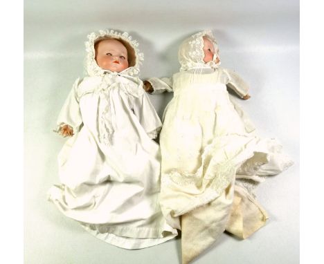 Two Armand Marseille German bisque headed baby dolls, 'AM' mark to the back of the neck, with cloth body, one with hand-carve
