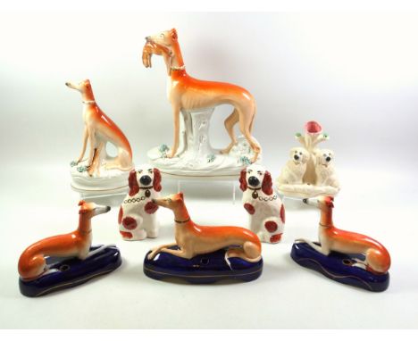 Victorian Staffordshire pottery model of a Greyhound, standing, with a hare in its mouth, on a naturalistic base, H.28cm; ano