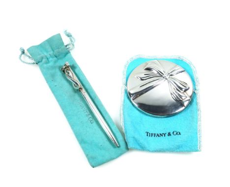 Tiffany &amp; Co. ballpoint pen with ribbon, marked "925 Sterling, Germany", L.12cm; and a silver plated circular mirror, Dia