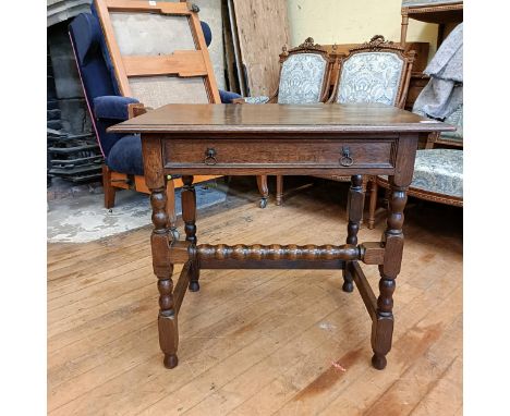 An oak side table, with a single frieze drawer, on bobbin turned legs, 80 cm wide 