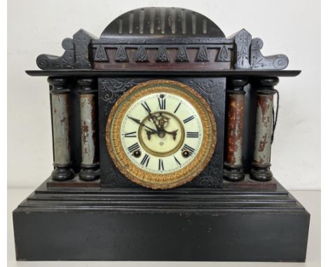 A mantel clock, in a slate case, 44 cm wide 