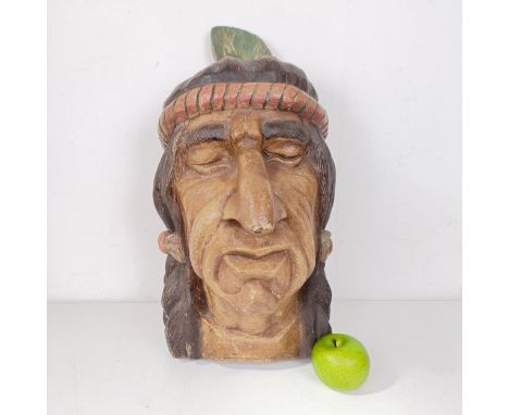 A wooden carving of a native Indian head, reportedly made as a promotional item for Players cigarettes, 55 cm high 