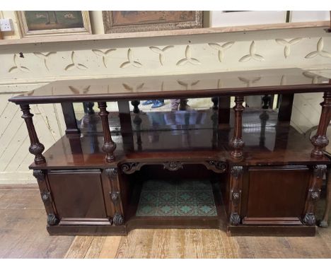 A large mahogany buffet, with central open section, with a tiled base, flanked by two cupboard doors, 190 cm wide 